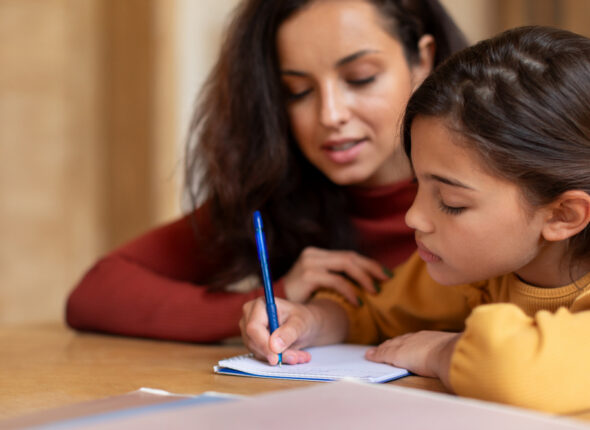 Arabic School Girl Having Lesson With Tutor, Writing Homework Indoors